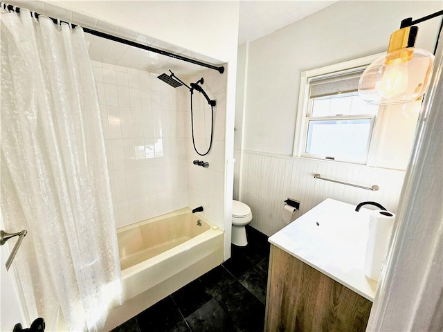 bathroom with wainscoting, shower / bathtub combination with curtain, toilet, and vanity