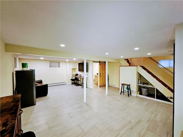 finished basement featuring stairs, a barn door, baseboard heating, and recessed lighting