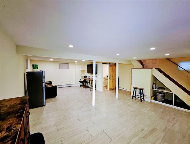 finished basement featuring a baseboard heating unit, recessed lighting, and stairway