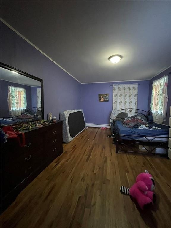 bedroom featuring wood finished floors and crown molding