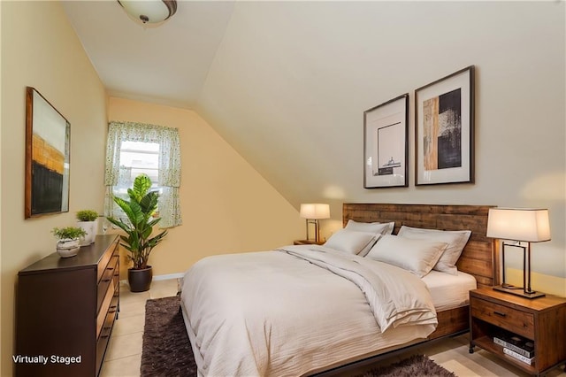 bedroom with lofted ceiling and light tile patterned flooring