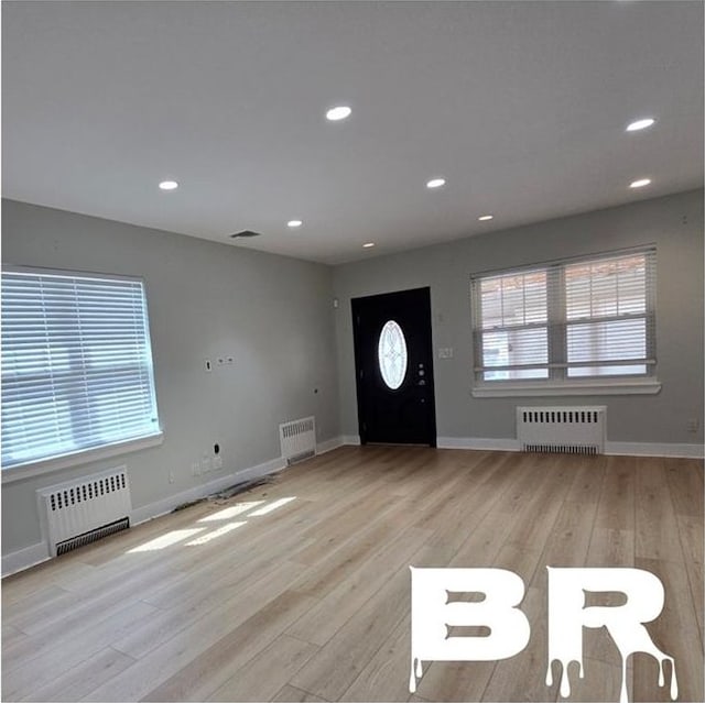 1300 Ave S, Brooklyn, NY 11229 - foyer entrance with radiator, recessed lighting, and light wood-style flooring