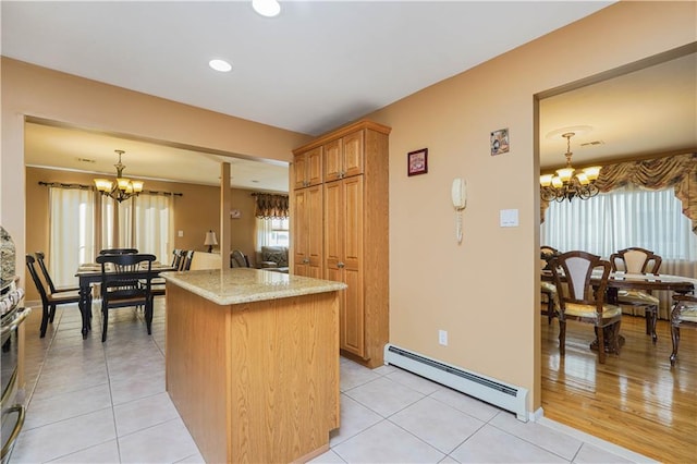 kitchen featuring a chandelier, pendant lighting, light tile patterned flooring, and baseboard heating