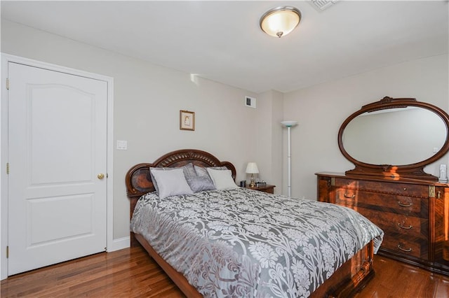 bedroom with visible vents and wood finished floors