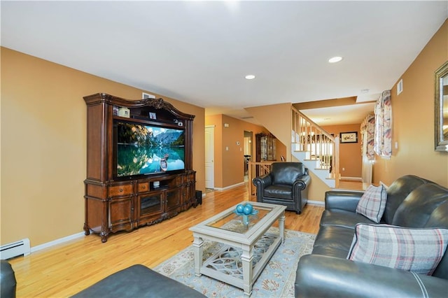 living room featuring recessed lighting, wood finished floors, baseboards, baseboard heating, and stairway