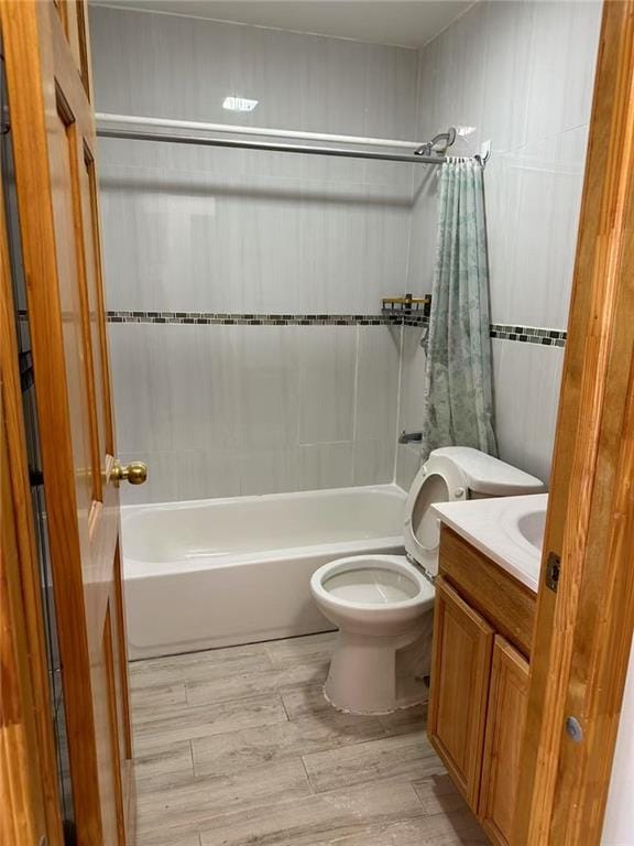 bathroom with shower / bath combo, vanity, toilet, and wood finished floors