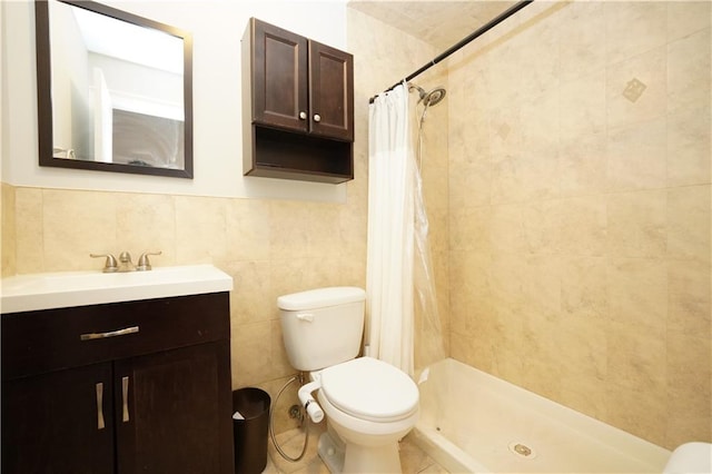 full bathroom with toilet, a shower stall, tile walls, and vanity