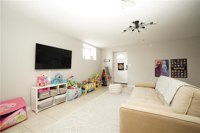 living area featuring baseboards, visible vents, and tile patterned floors