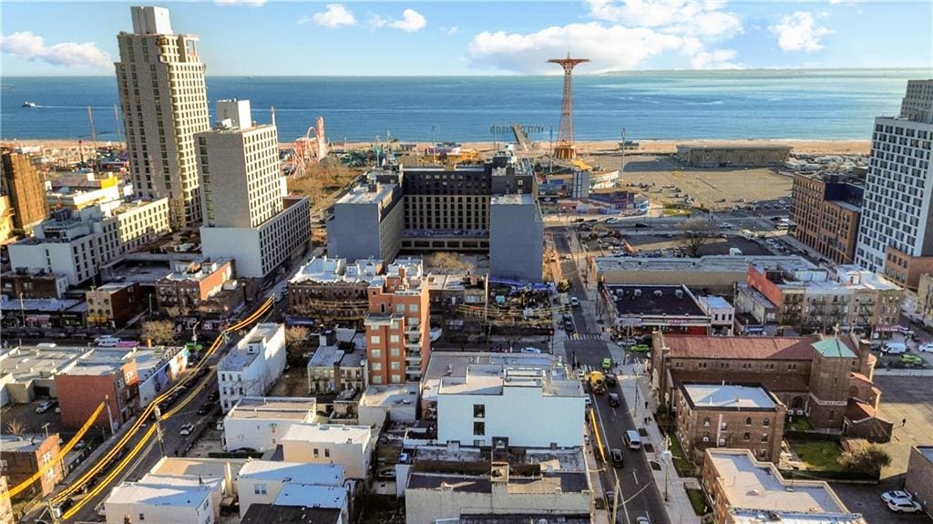 birds eye view of property featuring a view of city and a water view