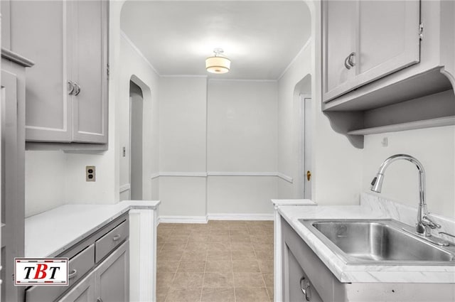 1615 I Ave Unit 511, Brooklyn, NY 11230 - kitchen featuring a sink, light countertops, arched walkways, ornamental molding, and gray cabinets
