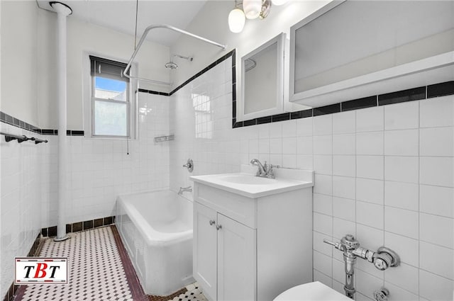 full bathroom featuring tile walls, toilet, shower / bath combination, and vanity