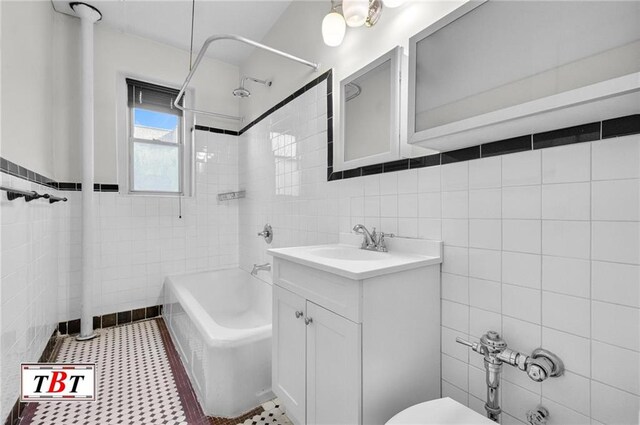1615 I Ave Unit 511, Brooklyn, NY 11230 - bathroom with tile walls, vanity, toilet, and washtub / shower combination