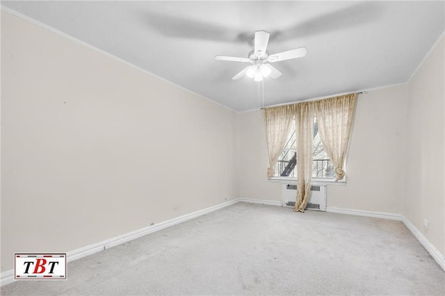 spare room featuring light carpet, baseboards, ceiling fan, and radiator