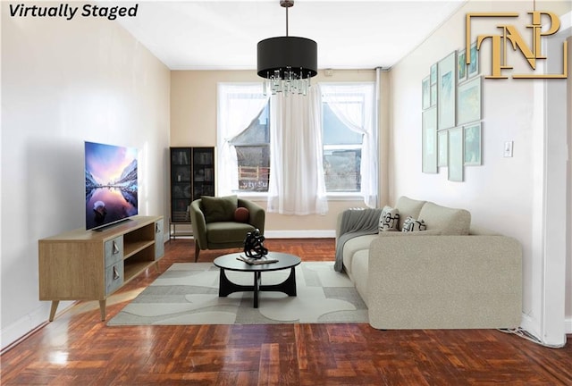 sitting room with an inviting chandelier, baseboards, and wood finished floors