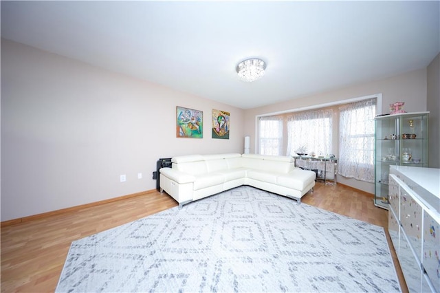 living area featuring baseboards and wood finished floors