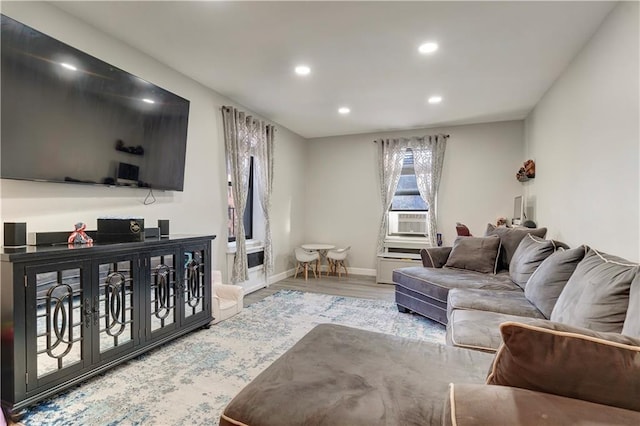 living room with recessed lighting, cooling unit, light wood-style flooring, and baseboards