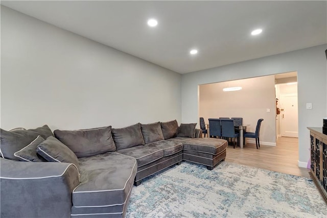 living room with recessed lighting, baseboards, and wood finished floors