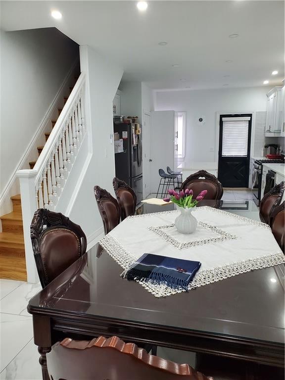 dining area with recessed lighting and stairs