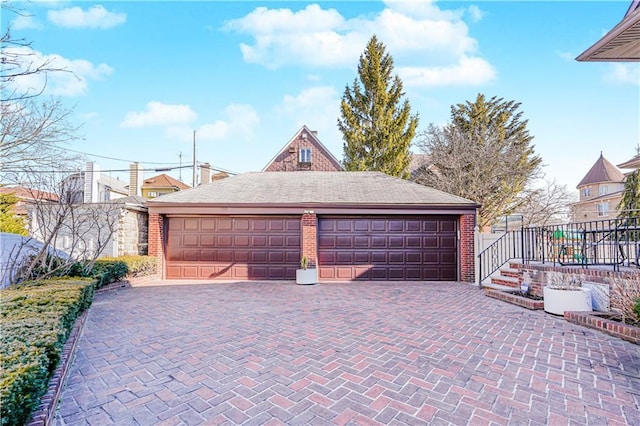 detached garage featuring fence