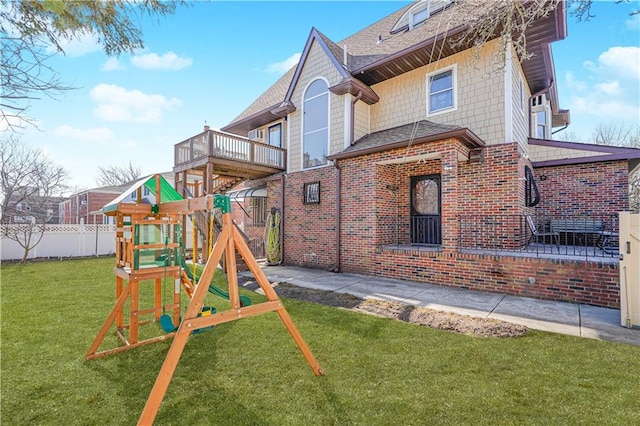 view of jungle gym featuring fence and a lawn