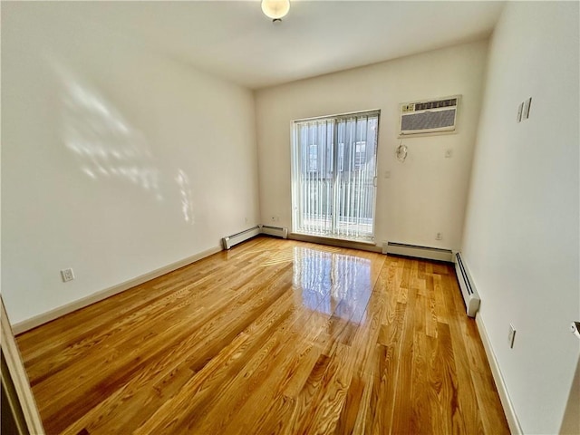 unfurnished room featuring baseboards, baseboard heating, a wall unit AC, and light wood-style floors