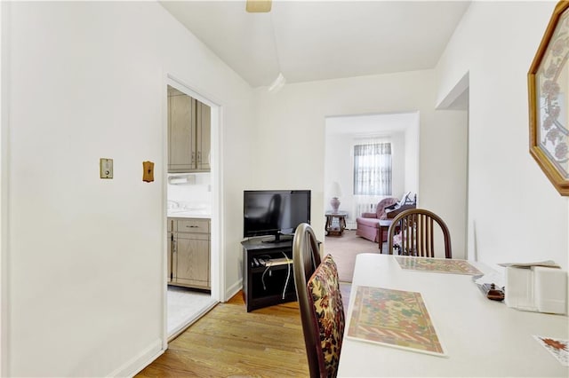 dining room with light wood-style flooring and baseboards