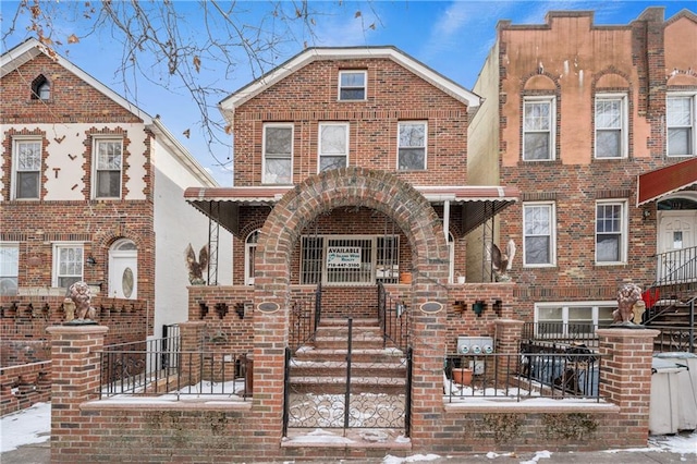 view of front of property with brick siding and a fenced front yard