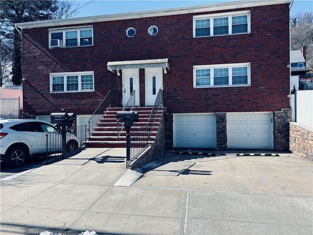 view of front of property featuring driveway, an attached garage, and brick siding