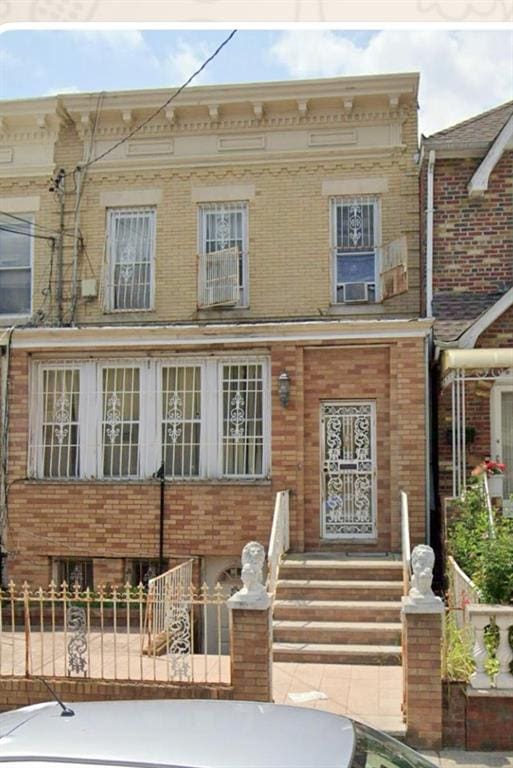 view of front of property with brick siding and a fenced front yard