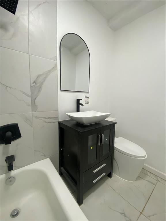 bathroom featuring vanity, walk in shower, toilet, marble finish floor, and a washtub