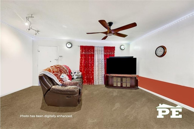 living area with carpet floors, crown molding, track lighting, and a ceiling fan