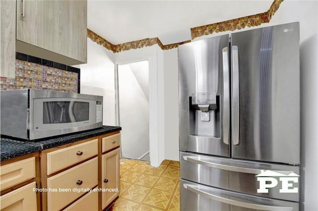 kitchen with stainless steel appliances, light floors, and backsplash