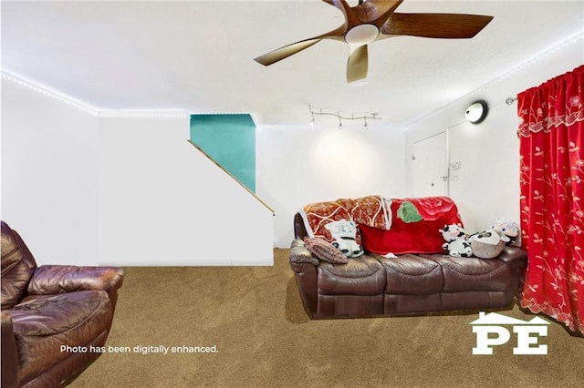 carpeted living area with ceiling fan and ornamental molding