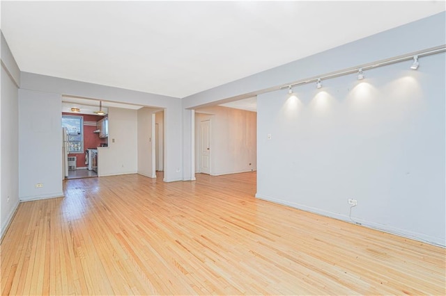 9707 4th Ave Unit 4W, Brooklyn, NY 11209 - unfurnished living room with track lighting and light wood-style flooring