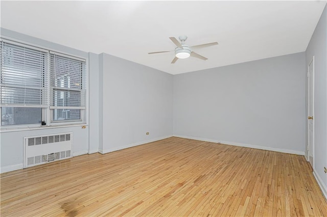 9707 4th Ave Unit 4W, Brooklyn, NY 11209 - spare room with radiator heating unit, hardwood / wood-style flooring, and ceiling fan