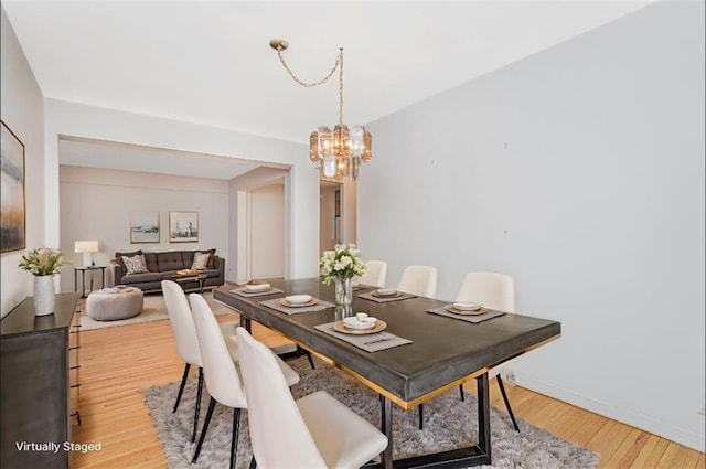 9707 4th Ave Unit 4W, Brooklyn, NY 11209 - dining space featuring a chandelier and light wood-style flooring
