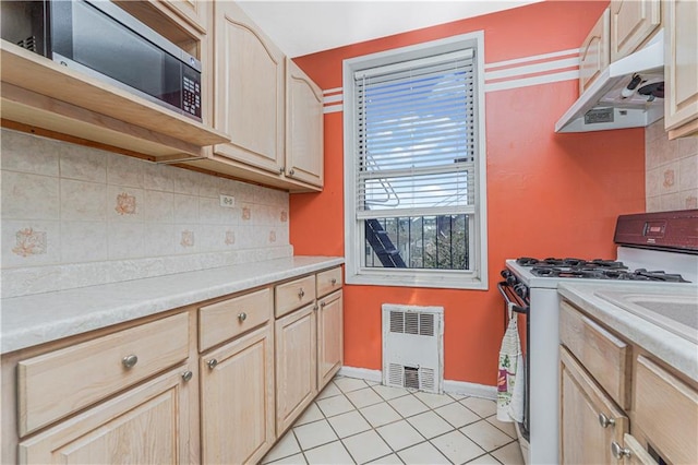 9707 4th Ave Unit 4W, Brooklyn, NY 11209 - kitchen with white gas range, under cabinet range hood, and light brown cabinetry
