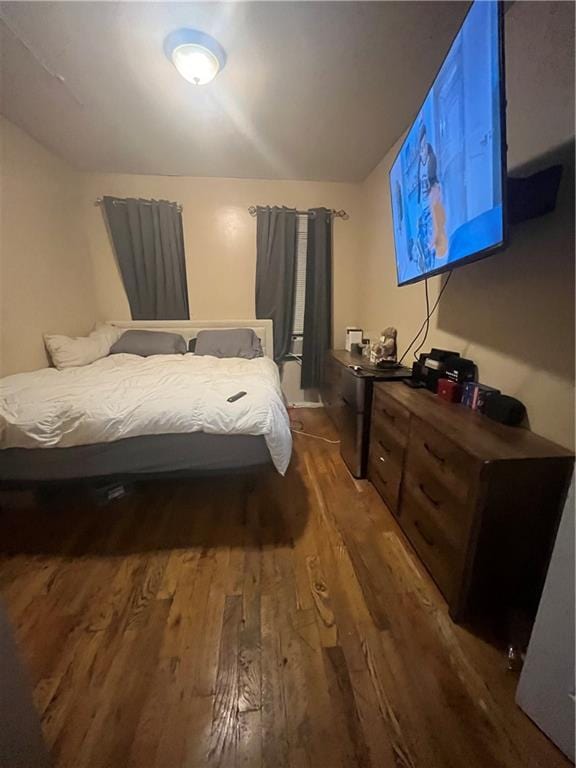 bedroom featuring dark wood finished floors