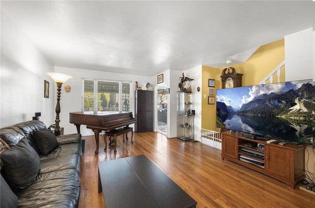 living room featuring stairs and wood finished floors