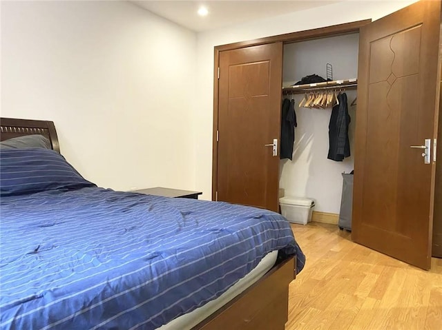 bedroom featuring light wood-style flooring and a closet