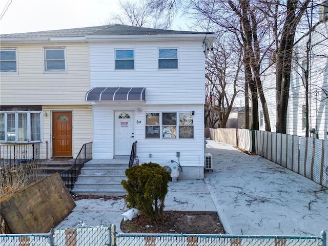 view of front of property with a patio and a fenced backyard