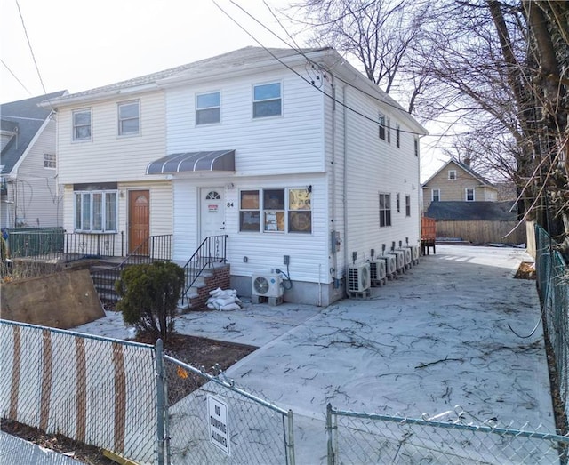 view of front of house with a fenced front yard and ac unit