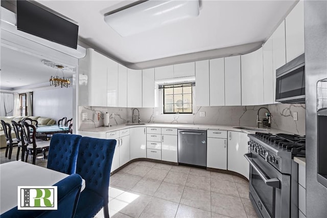 kitchen featuring stainless steel appliances, a sink, and light countertops