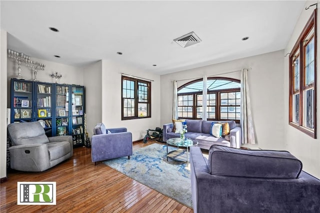 living room with hardwood / wood-style flooring and visible vents