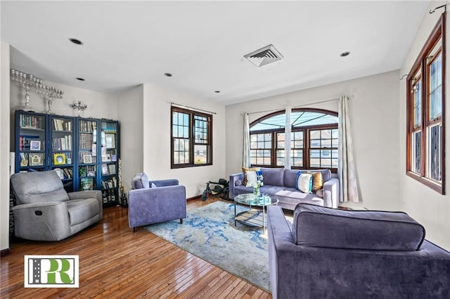 living area with hardwood / wood-style flooring, baseboards, visible vents, and recessed lighting