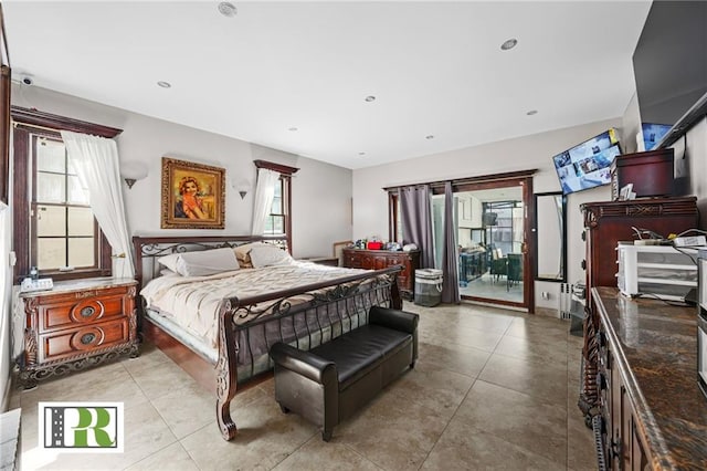 bedroom with light tile patterned floors and access to exterior