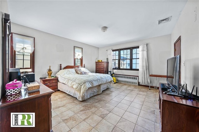 bedroom featuring light tile patterned floors, visible vents, and radiator