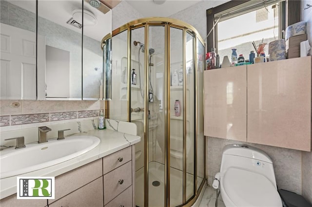 bathroom featuring vanity, tasteful backsplash, a shower stall, and toilet