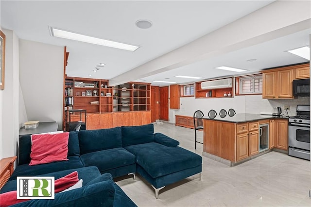 living area featuring wine cooler and a wall mounted AC