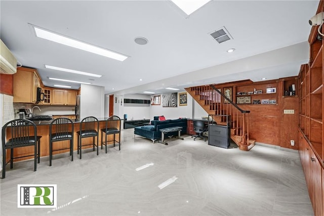 living room featuring visible vents and stairway